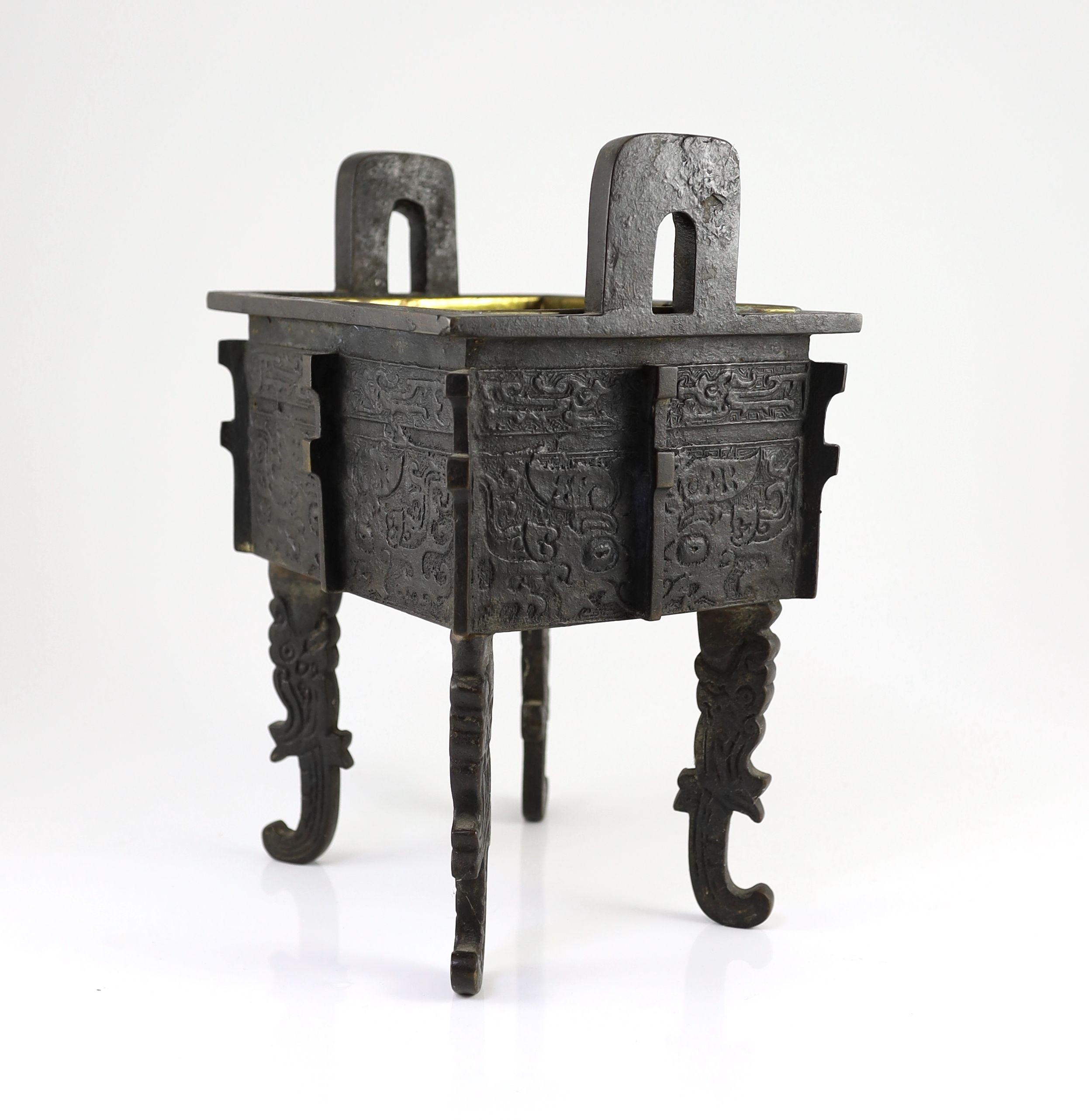 A Chinese archaistic bronze rectangular censer, fangding, 17th/18th century 34cm high, 24cm wide, 20cm depth later liner and repairs to legs